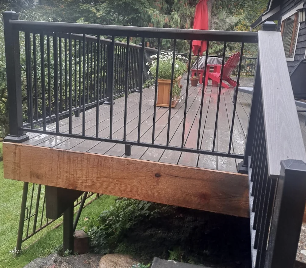 Finished deck with black metal railing and new rim board